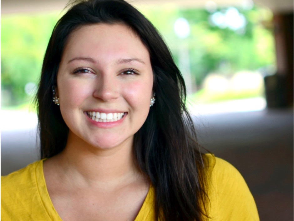 Smiling female with yellow shirt outside
