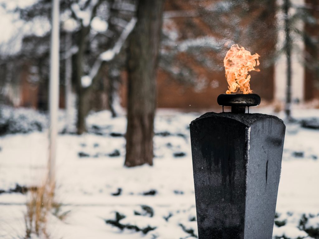 flame in foreground, snow filled background
