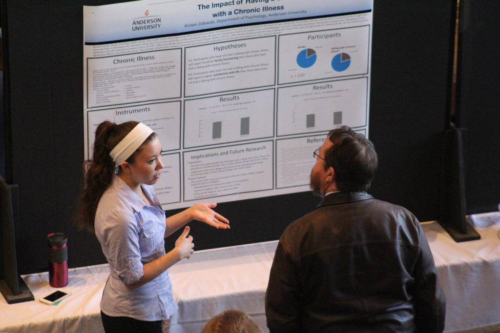 Teacher and student talking during Scholars' Day